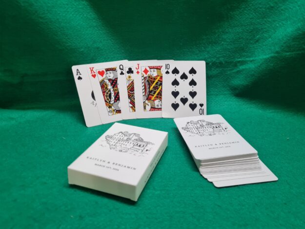 20260611_140842 Wedding favours with playing cards featuring a custom venue illustration and the couple's names and date.