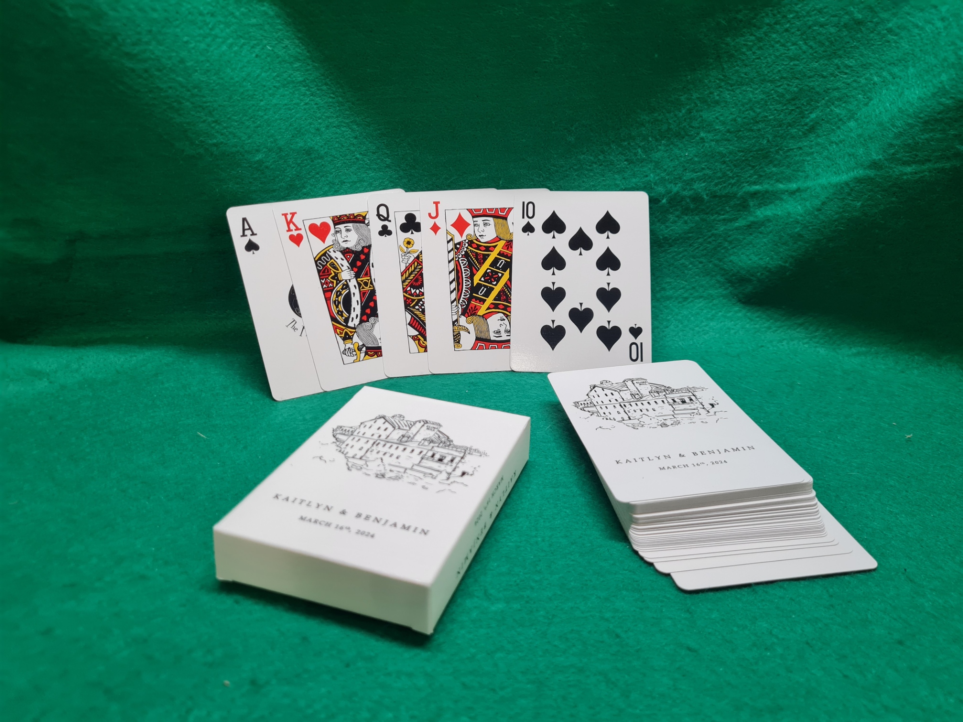 Wedding favours with playing cards featuring a custom venue illustration and the couple's names and date.