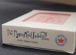 Close-up of the bottom of a custom playing card tuck box showing The Playing Card Factory logo, "© 2021 Made in Canada" text, and an "Ontario Made – Fabriqué en Ontario" seal with a red maple leaf, with the blush pink card back visible through the window above.